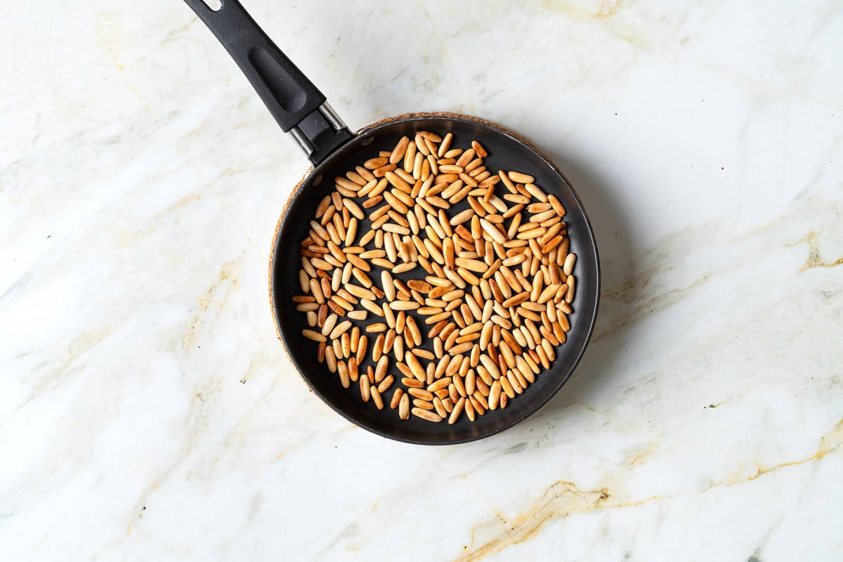 pine nuts toasting in a skillet.