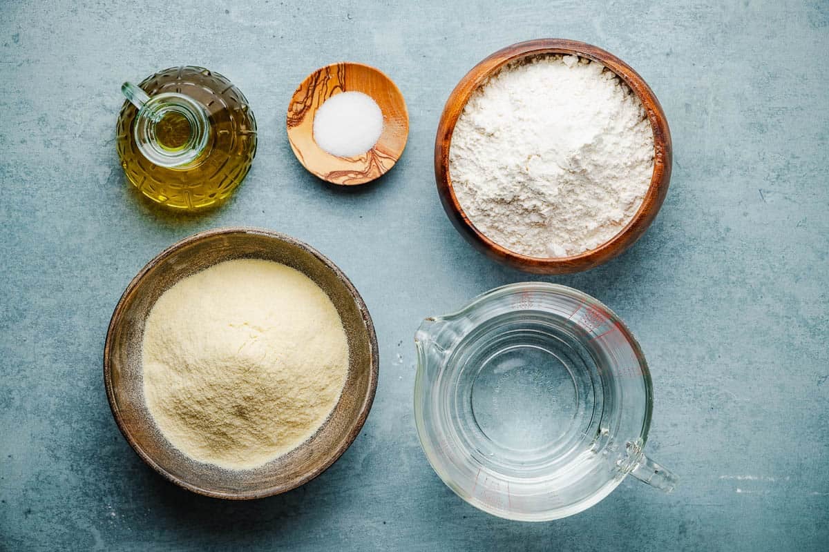 Ingredients for mlewi flatbread including all purpose flour, fine semolina, salt, water, and olive oil.