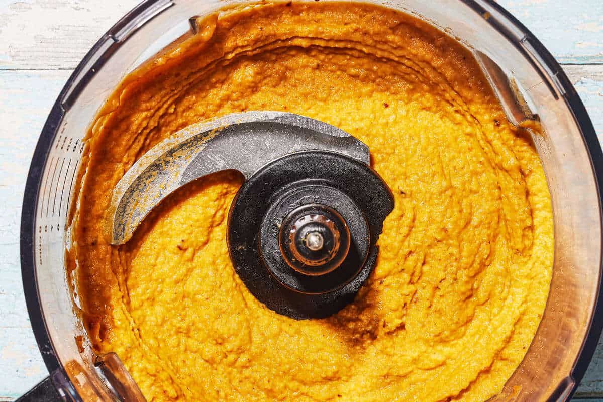 Pumpkin hummus that has been blended, showing a nice smoothness but still a small amount of texture.