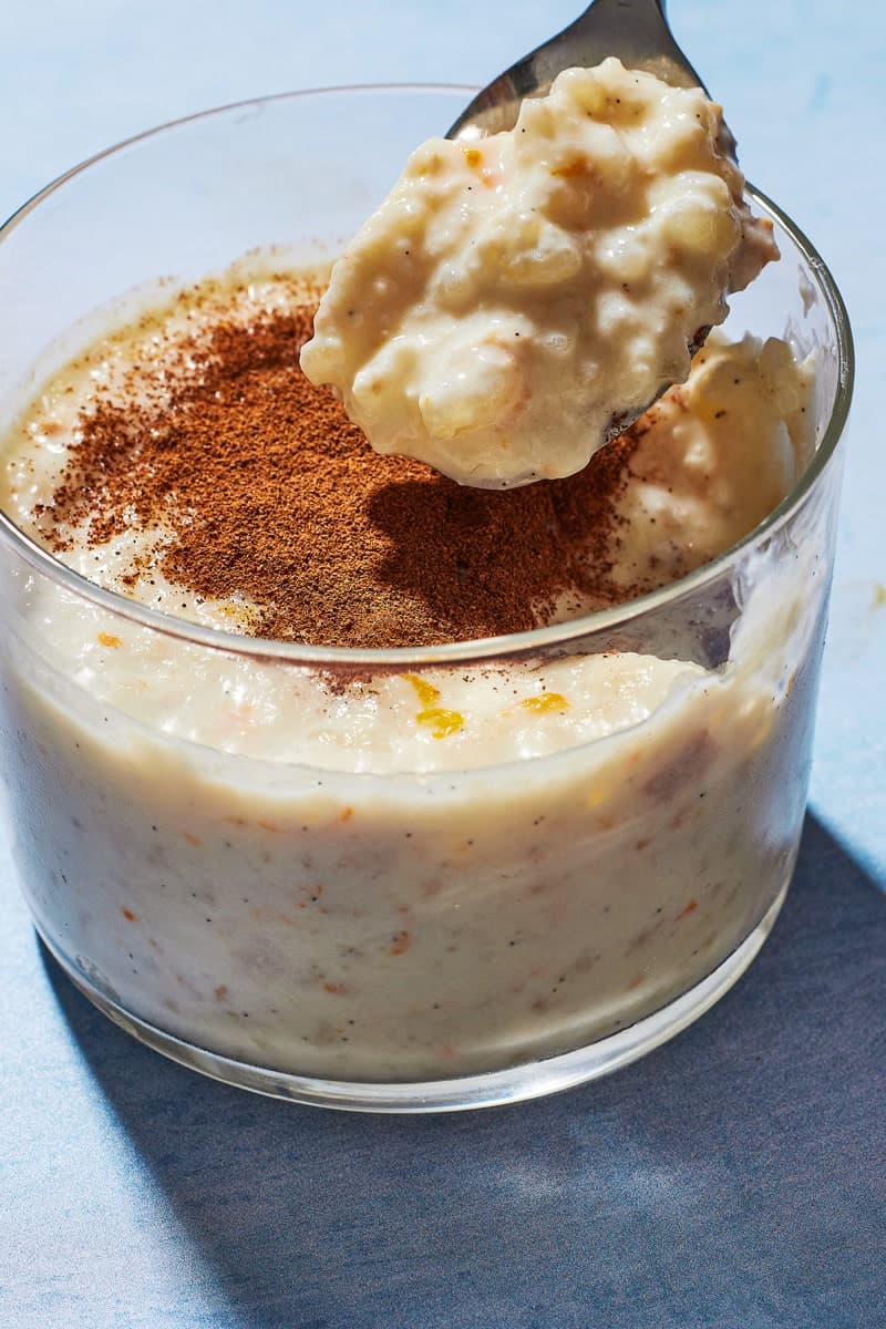 A spoon showing a scoop of Rizogalo, showing the plump rice and creamy texture.