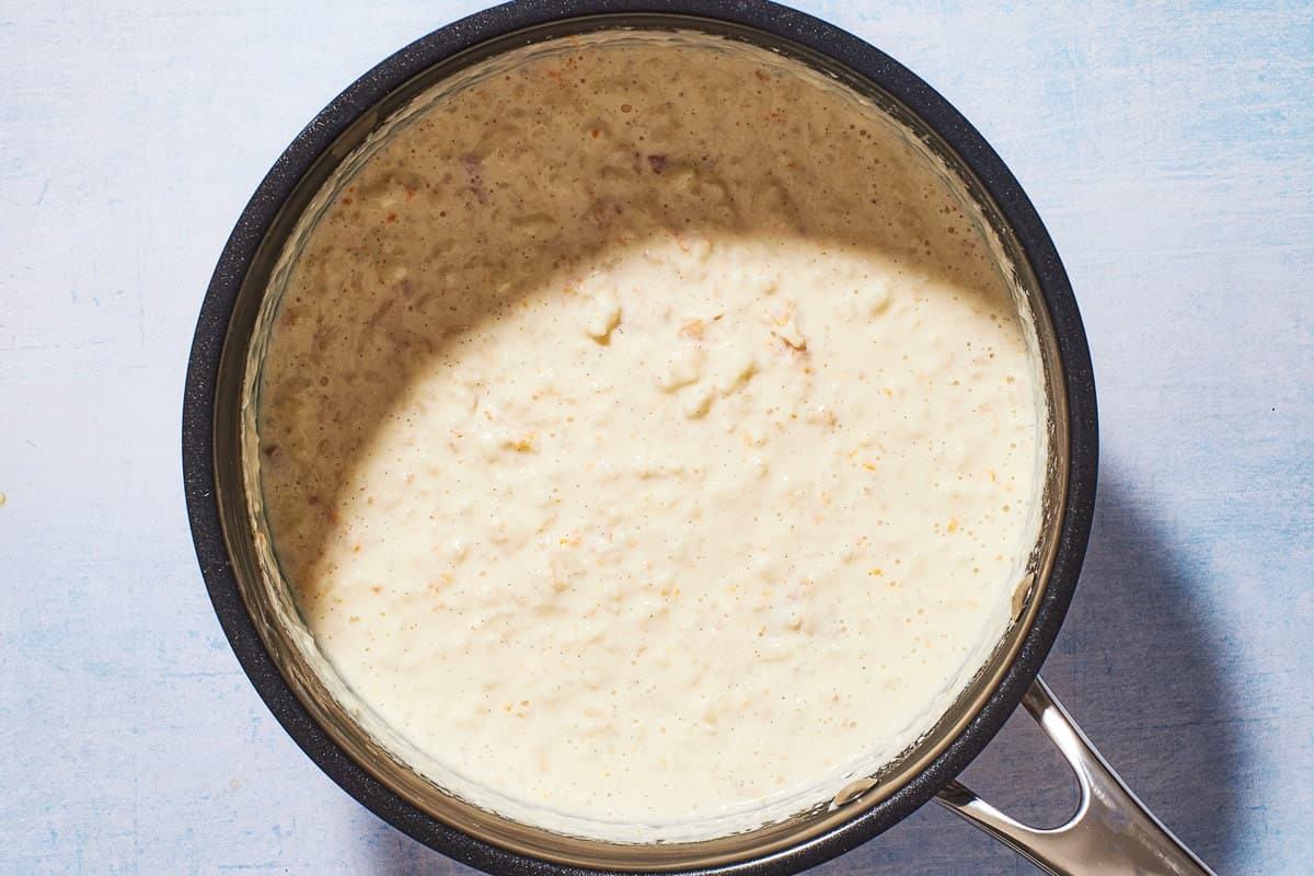 a pot of Rizogalo after it has cooked, showing the thickened consistancy and plump rice.