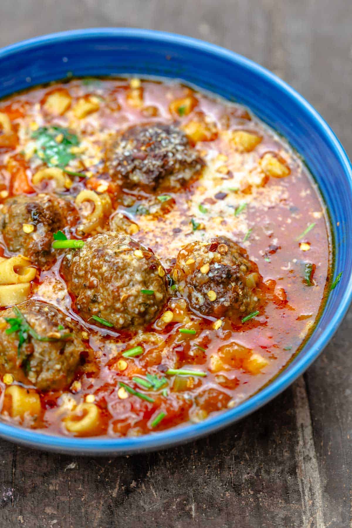 a close up of a bowl of meatball soup.