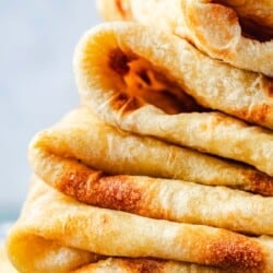 close up of a stack of folded of mlewi flatbreads.