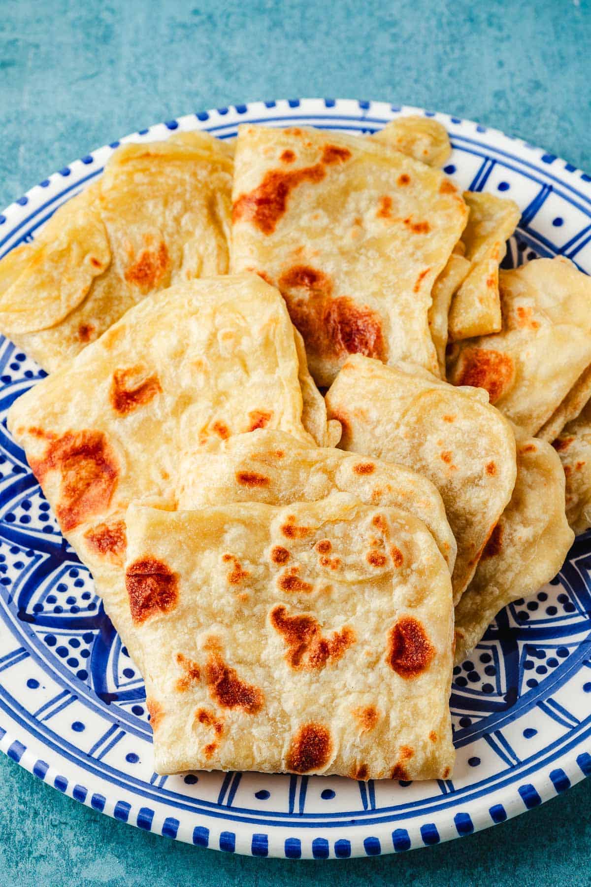 folded mlewi flatbreads on a plate.