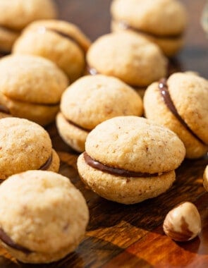 a close up of baci di dama hazelnut cookies placed on a table.