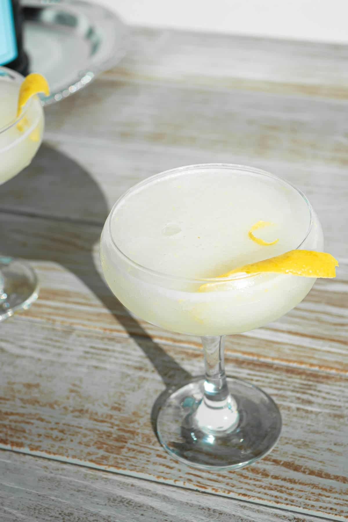 a sgroppino prosecco cocktail garnished with lemon peels.