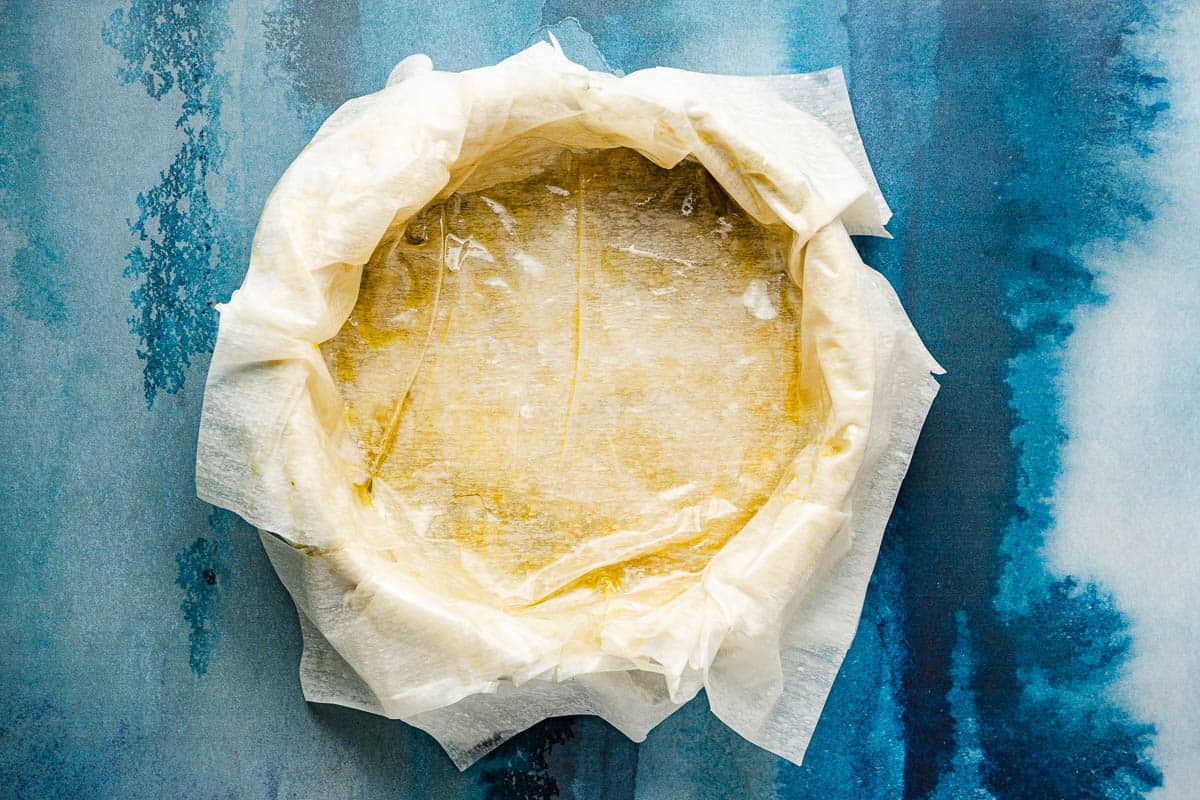 layers of phyllo dough placed on the bottom of a baking pan and brushed with olive oil.