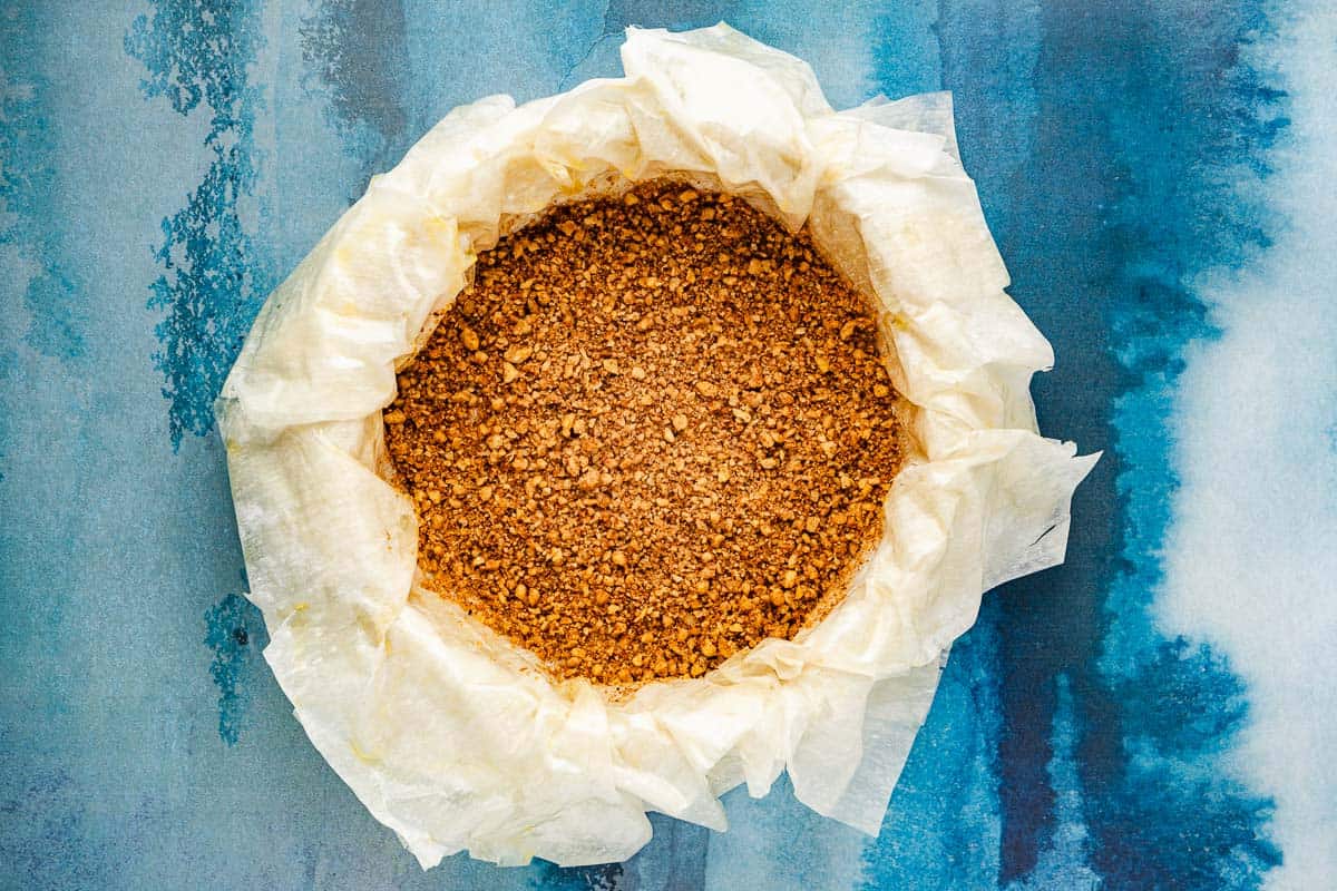 layers of phyllo dough placed on the bottom of a baking pan, brushed with olive oil and topped with a layer of the walnut crumble.