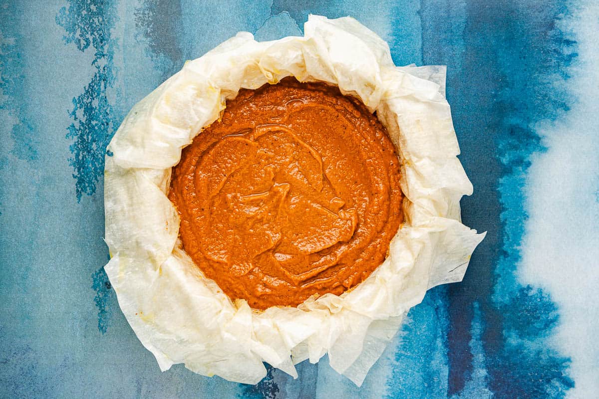 layers of phyllo dough placed on the bottom of a baking pan topped with a layer of the pumpkin pie filling.