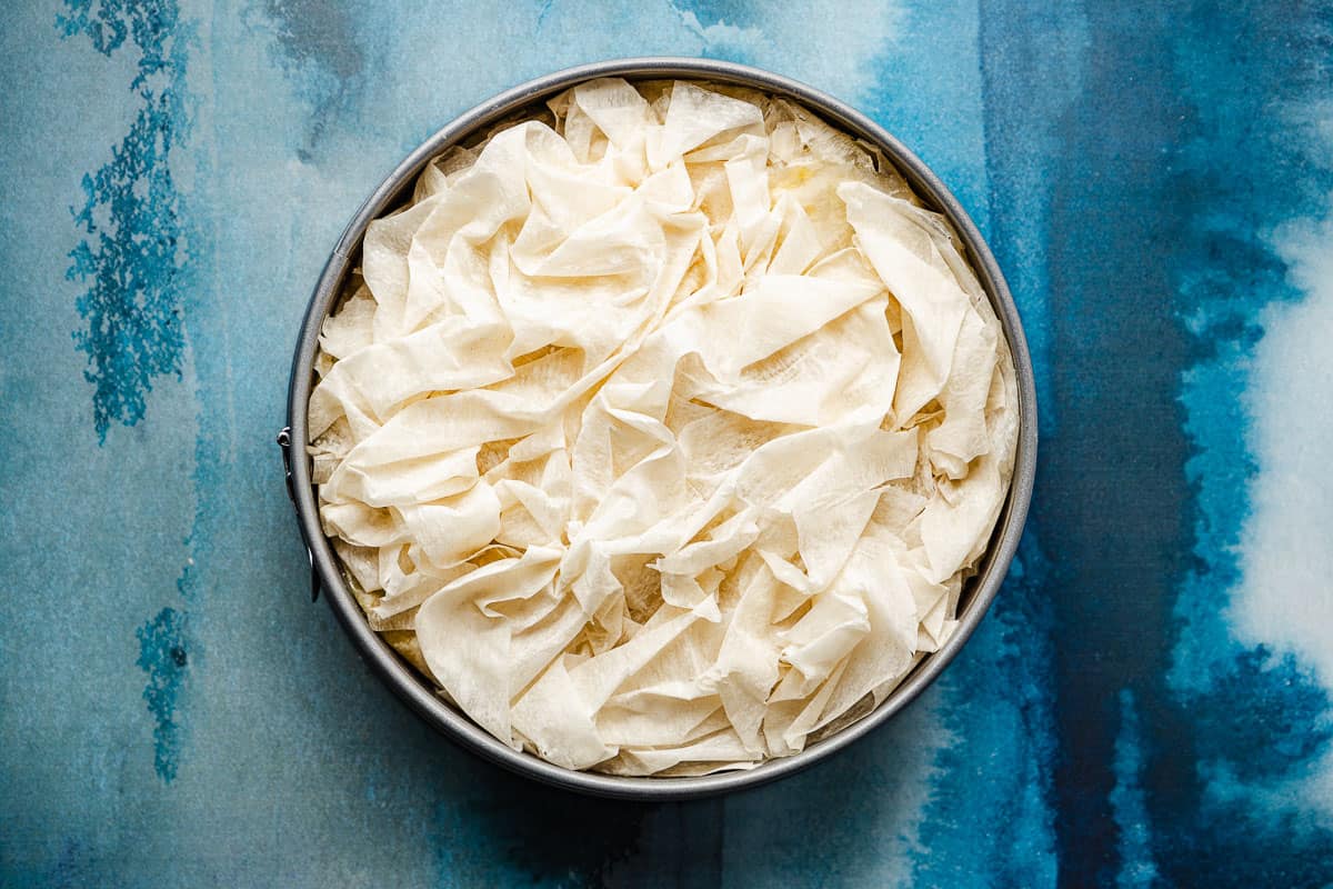 an unbaked baklava pumpkin pie in a baking pan.