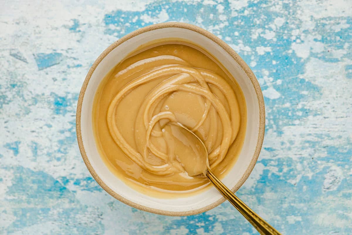 Honeyed tahini being mixed in a small bowl.