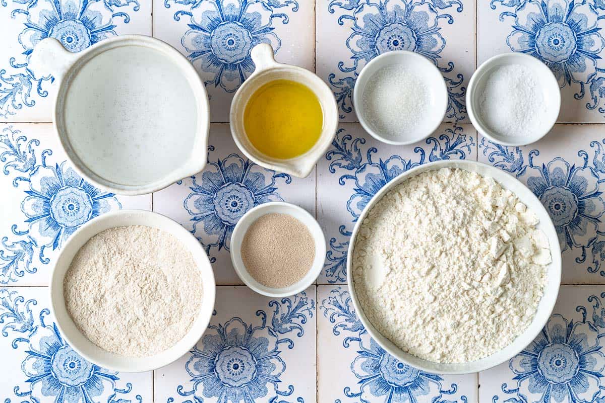 ingredients for taboon flatbread including water, yeast, sugar, all purpose flour, wheat flour, sea salt, and olive oil.