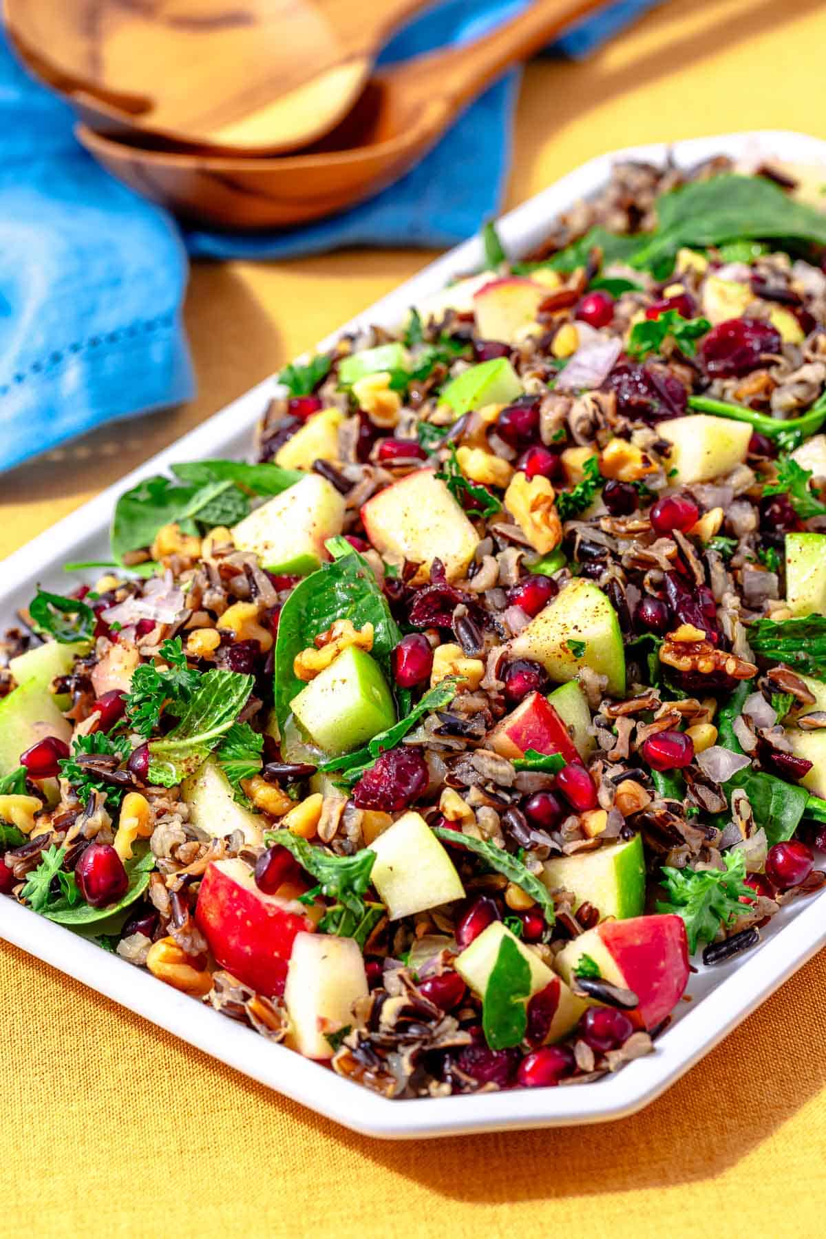 side shot of wild rice salad on a rectangular serving platter.
