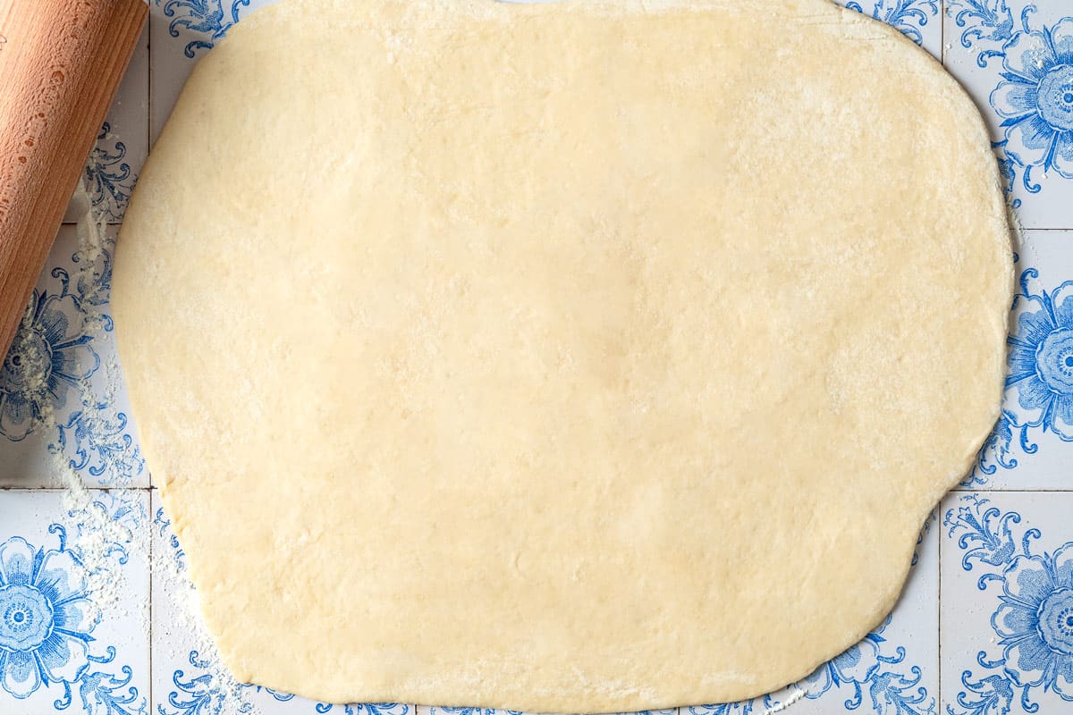 Dough for fatayer rolled out onto a countertop.