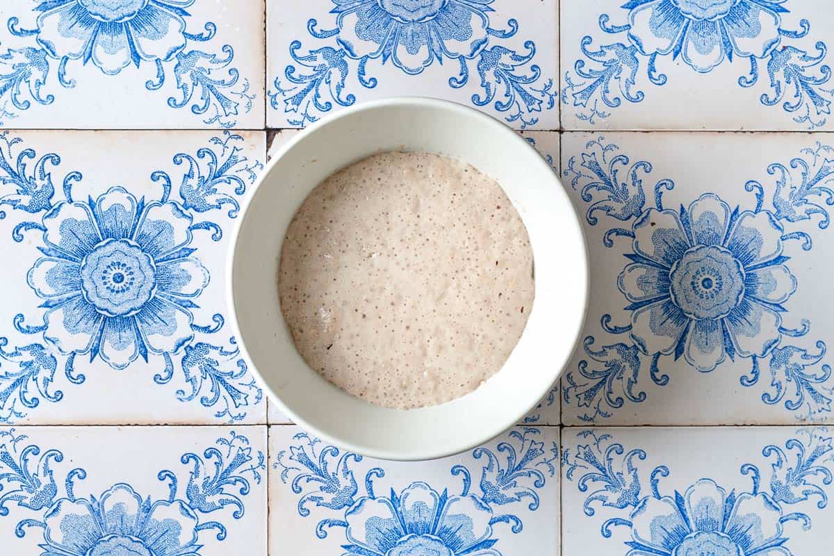 Yeast for the fatayer dough being activiated in a small white bowl.