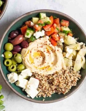 An overhead photo of a mediterranean bowl with quinoa.