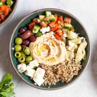 An overhead photo of a mediterranean bowl with quinoa.