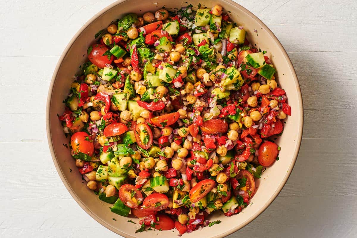 a close up of vegan chickpea salad in a serving bowl.
