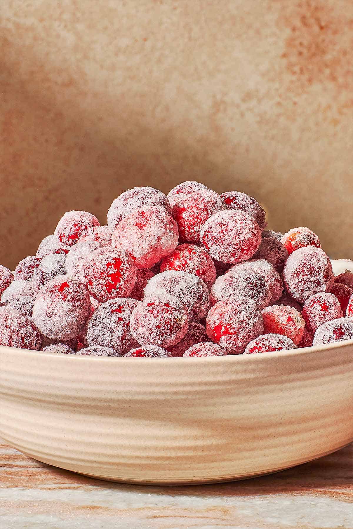 a close up of sugared cranberries in a serving bowl.