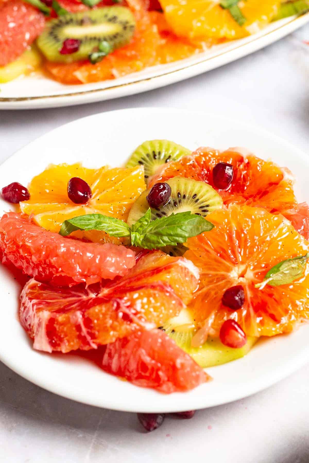 a tropical up of a serving of citrus salad on a plate.