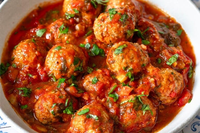 a close up of a serving of moroccan fish kofta in a bowl.