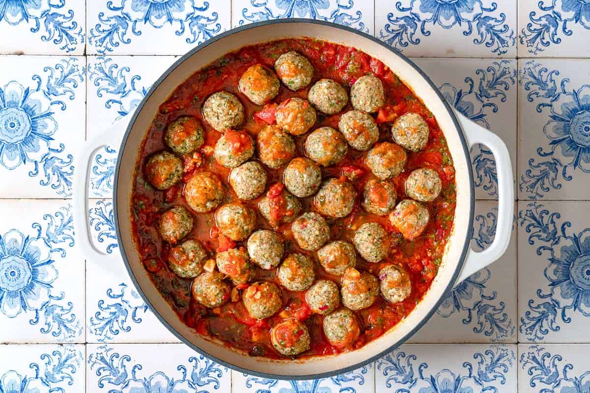 an overhead photo of moroccan fish kofta in a large pot.