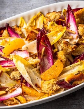 a close up of endive salad in a serving bowl.