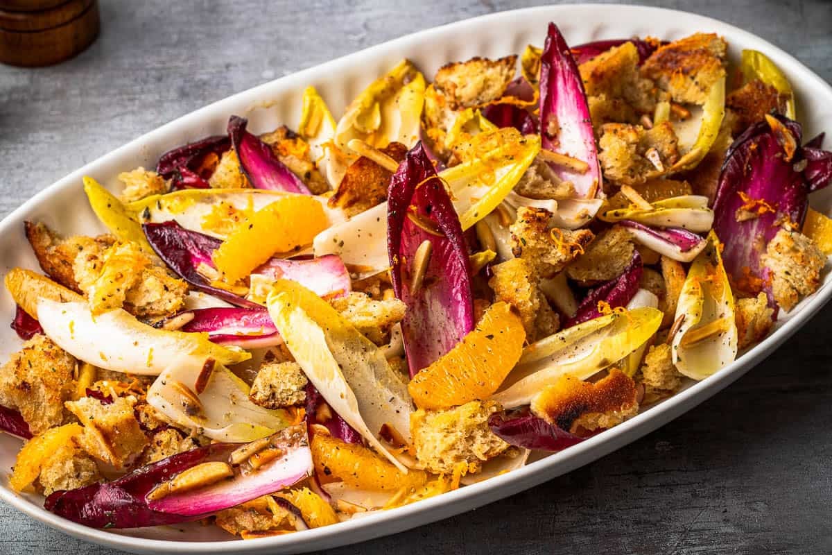 a close up of endive salad in a serving bowl.