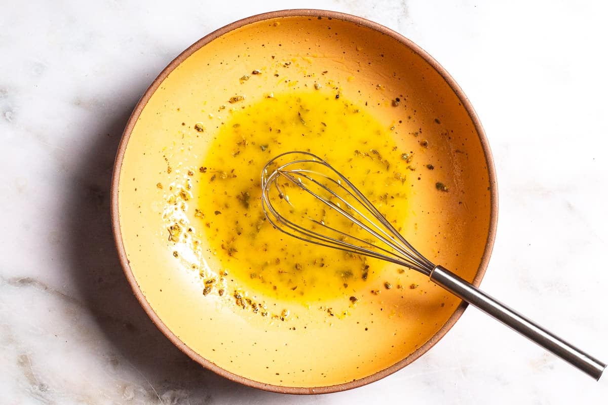 the dressing for the quinoa salad in a large bowl with a whisk.