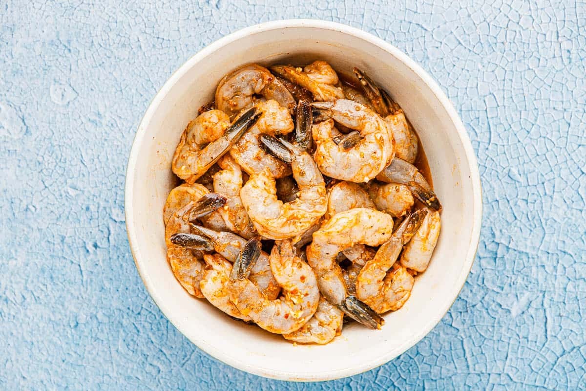 shrimp marinating in a bowl.