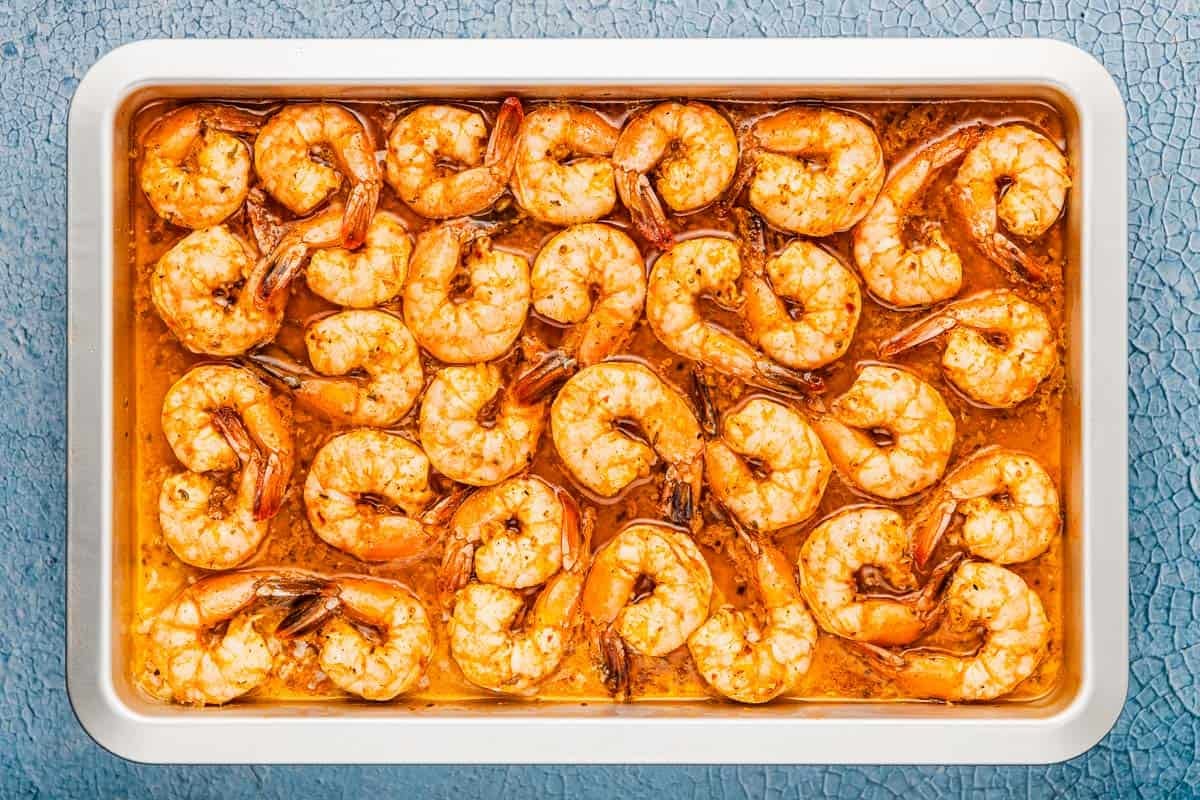 an overhead photo of sheet pan shrimp in sauce.