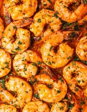 a close up of sheet pan shrimp in sauce.