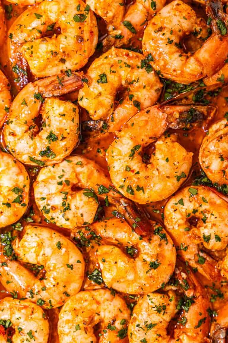 a close up of sheet pan shrimp in sauce.
