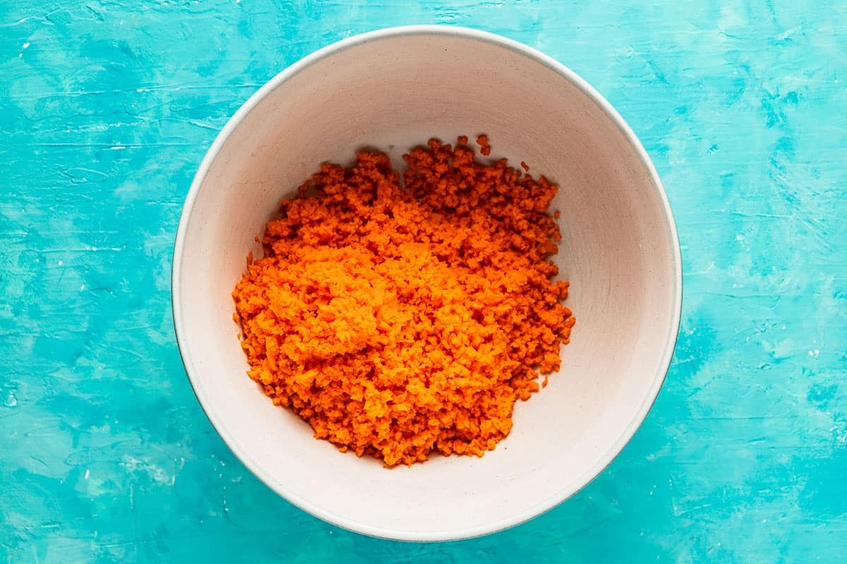 finely shredded carrots in a white bowl.