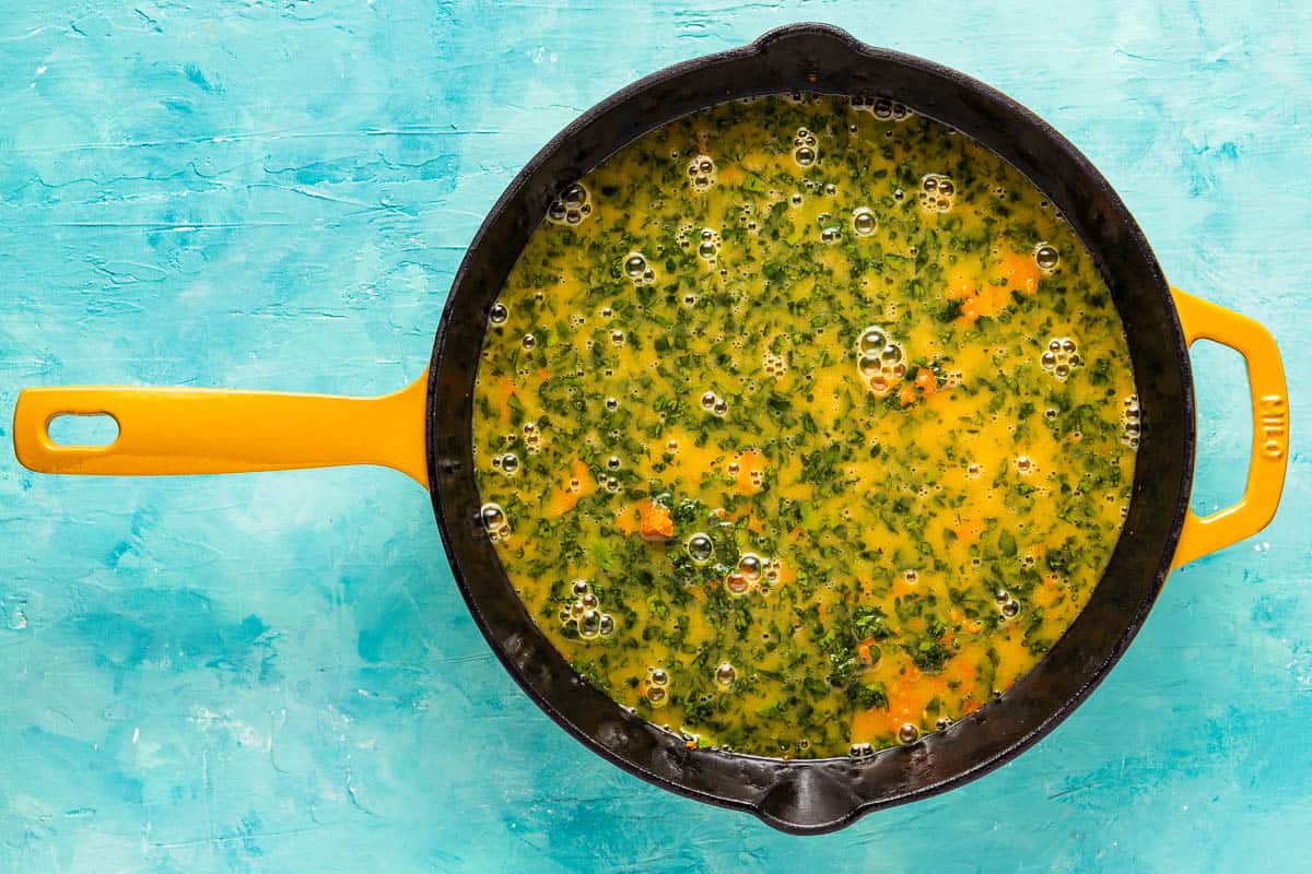 tunisian style frittata with carrot in a skillet before being baked.