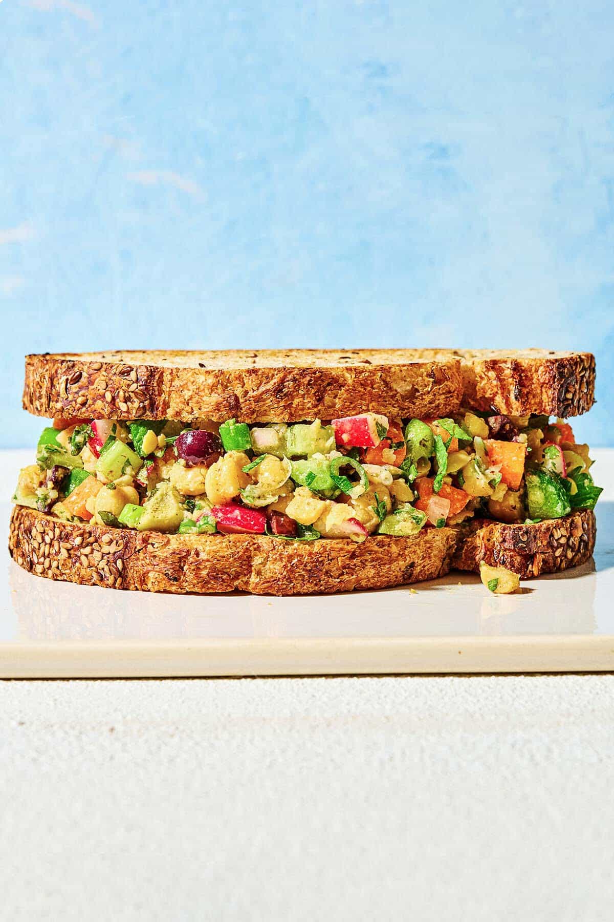a close up of a vegan chickpea salad sandwich.