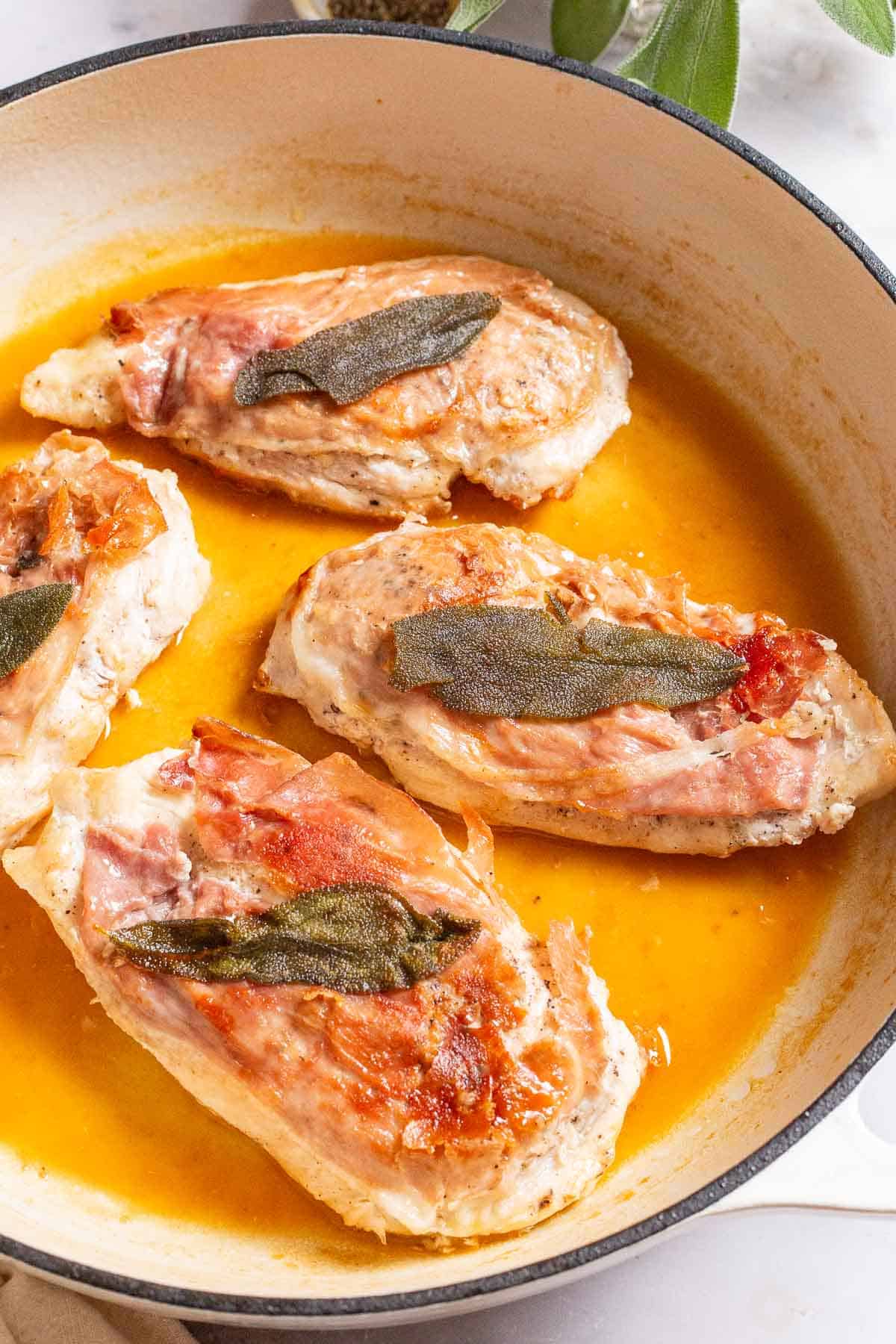 A close up of chicken saltimbocca in a skillet.