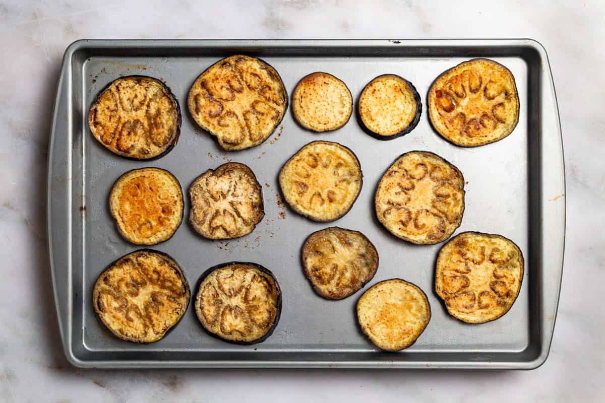 roasted eggplant slices on a baking sheet.