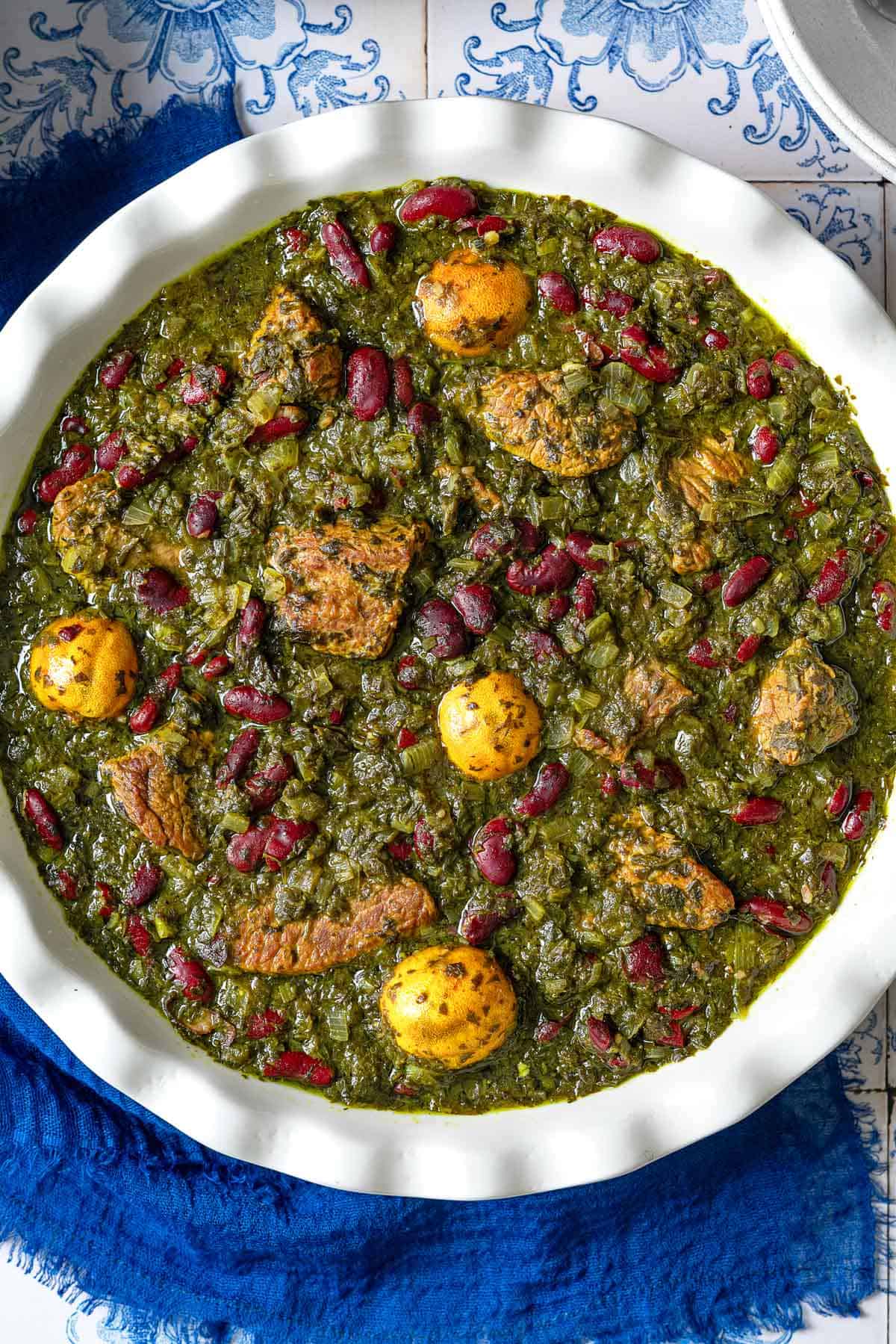 A close up of ghormeh sabzi in a serving bowl.