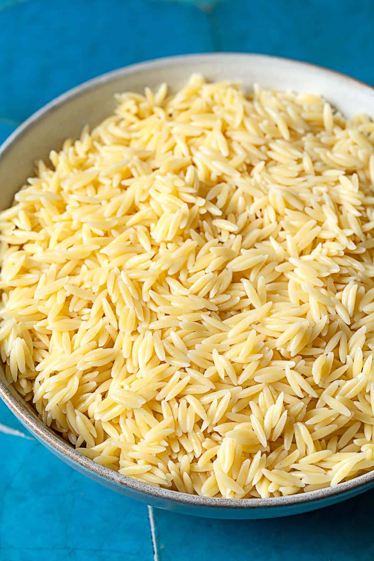 Cooked orzo pasta in a bowl.