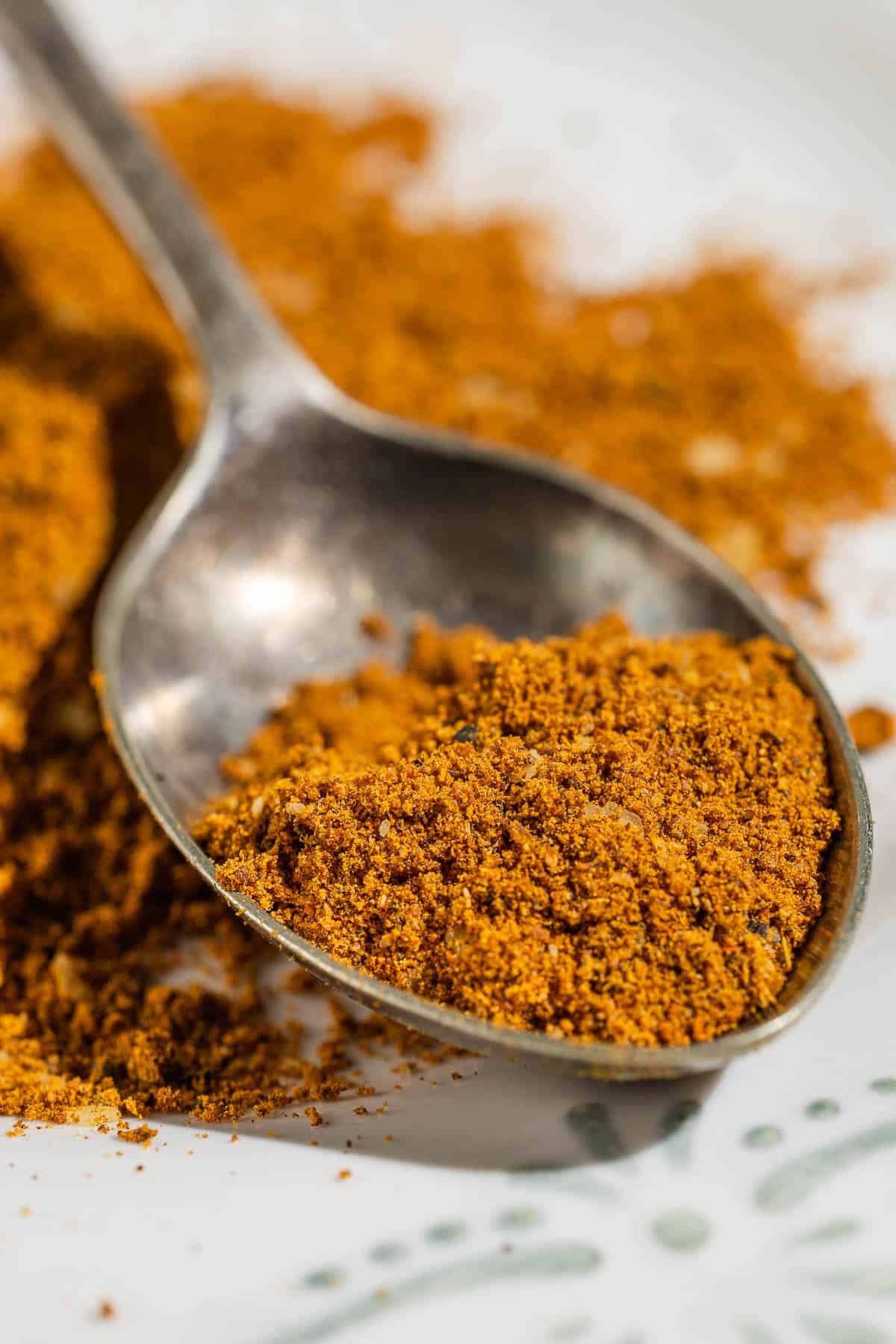 a close up of ras el hanout on a spoon.