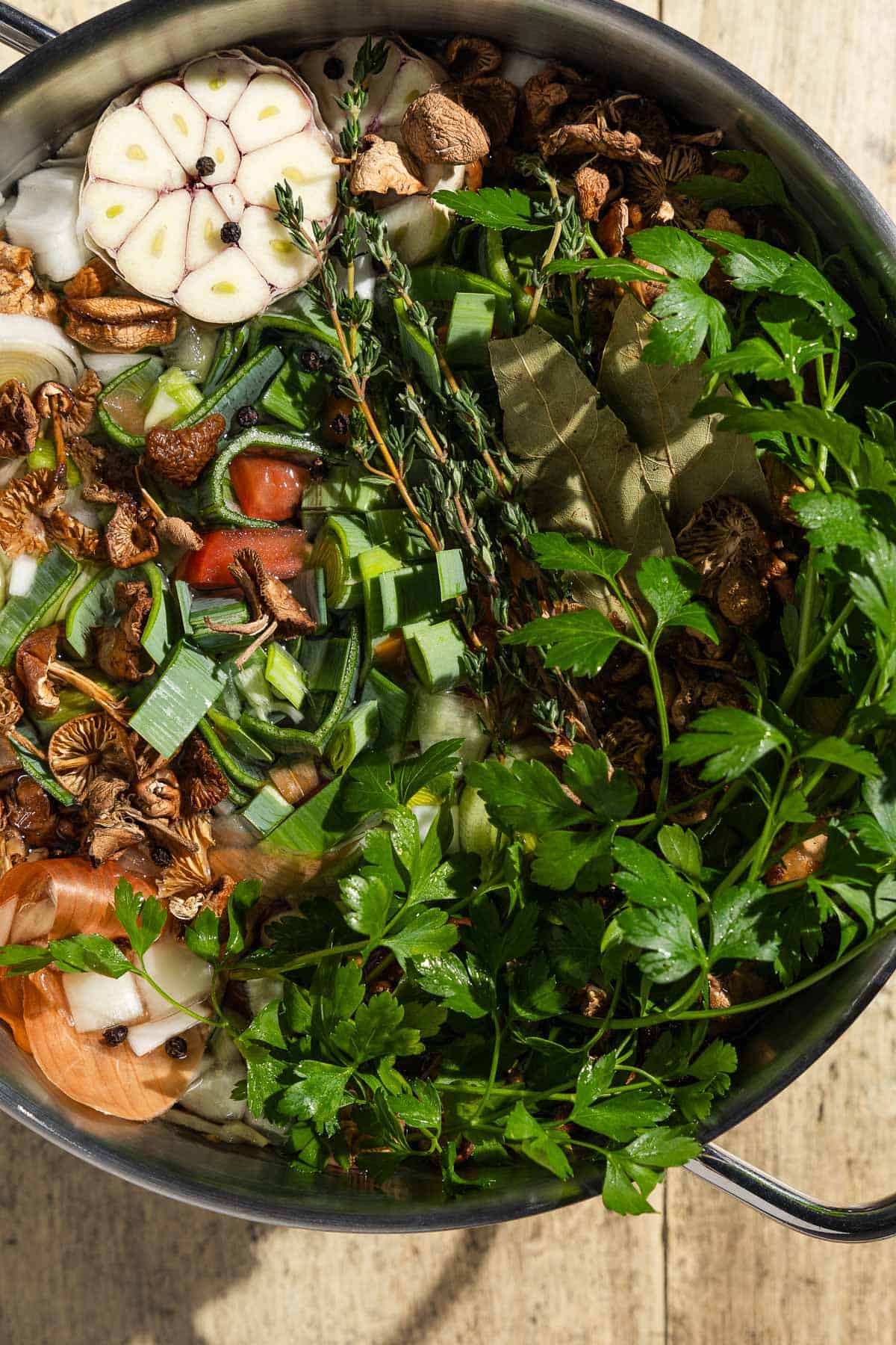 An overhead photo of all the ingredients for the homemade vegetable stock in a pot before the water is added.