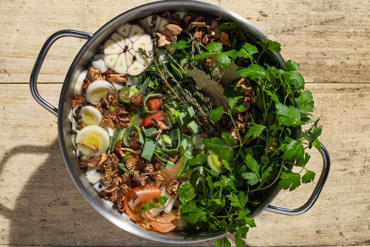 An overhead photo of all the ingredients for the homemade chicken stock in a pot before the water is added.