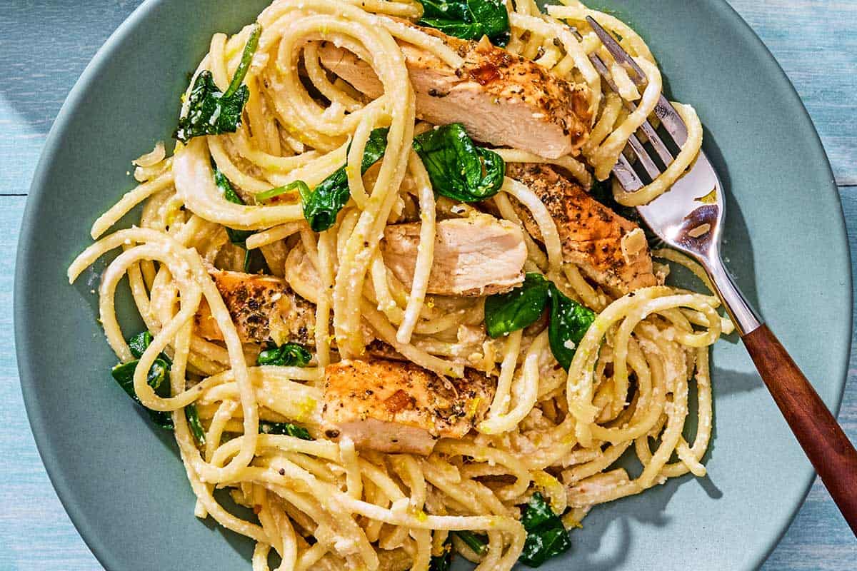 Lemon chicken pasta on a plate with a fork.