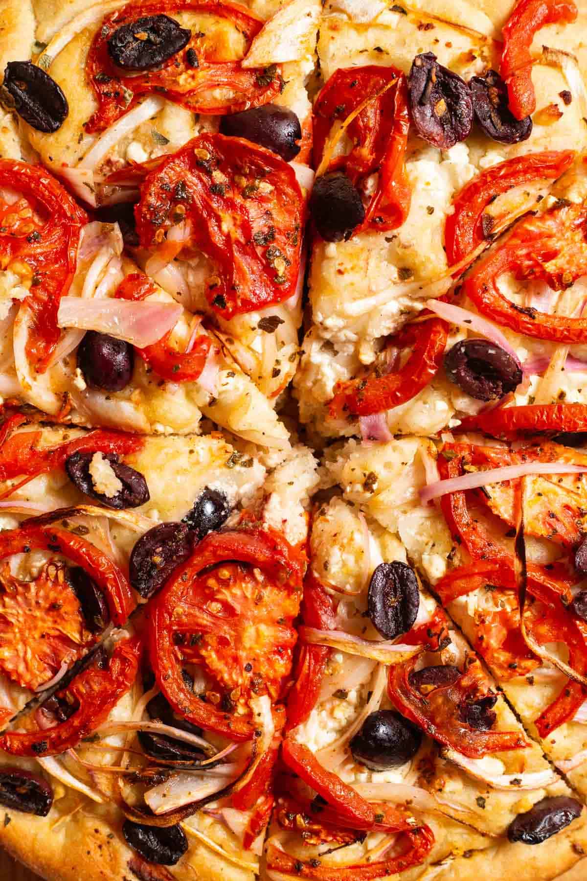 A close up photo of greek pizza.