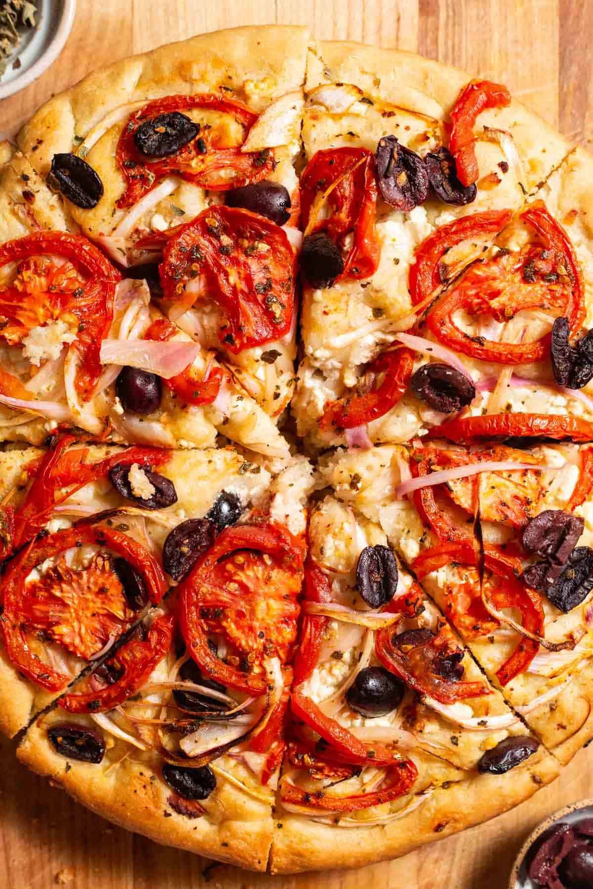 A close up photo of greek pizza.