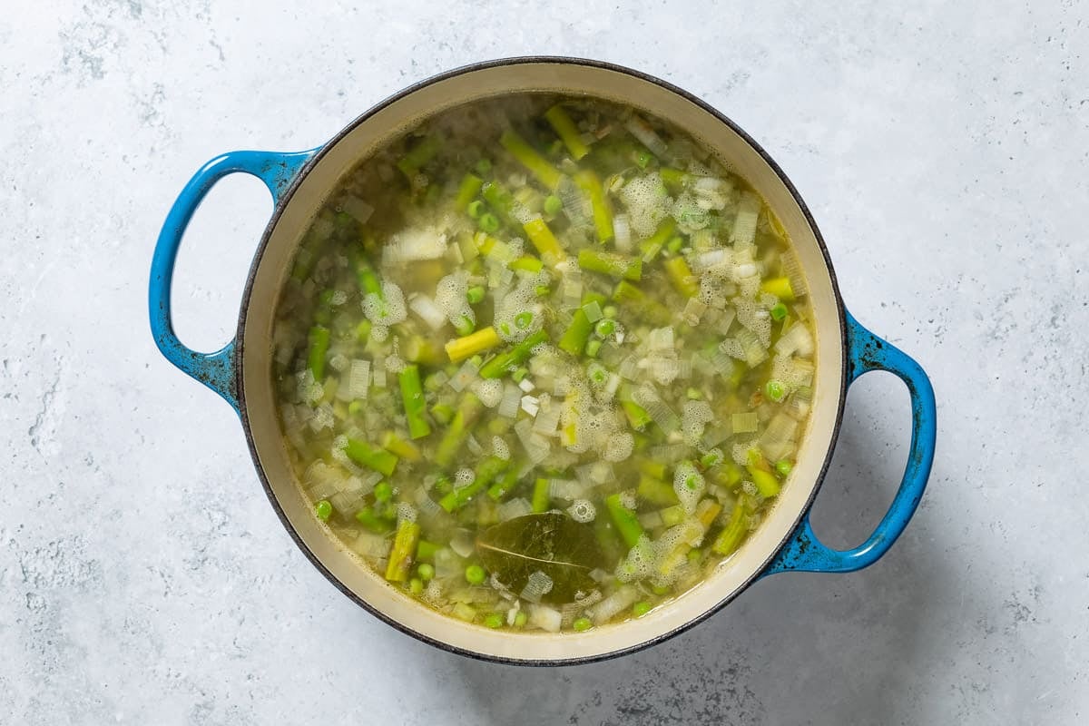 An overhead photo of the asparagus soup before the ingredients have been blended together.