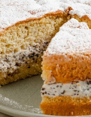 A close up of the easy cassata cake on a serving platter with a slice cut a part from it.