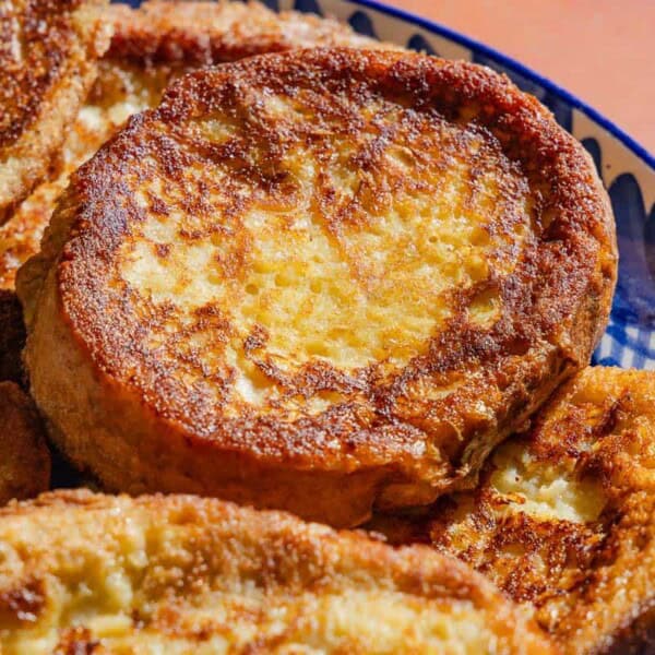 A close up photo of several torrijas on a serving platter.