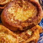 A close up photo of several torrijas on a serving platter.